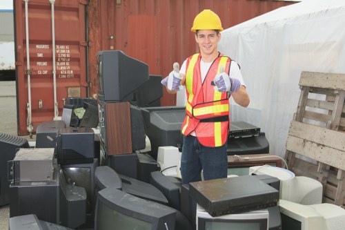 Team sorting office furniture for recycling during an office clearance in Norwood