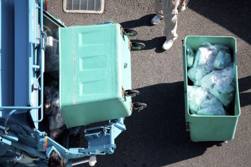Crew preparing a half-lorry load at a terraced commercial property