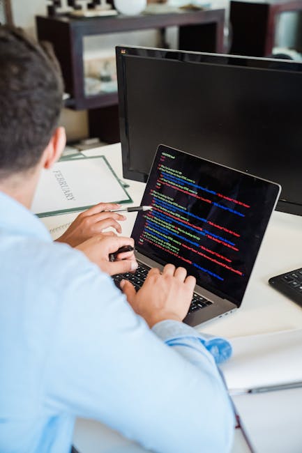 Close-up photograph of a computer screen displaying HTML code within a text editor. The code includes tags such as <DOCTYPE html>, <html>, <head>, and <body>, with some meta tags and a stylesheet link